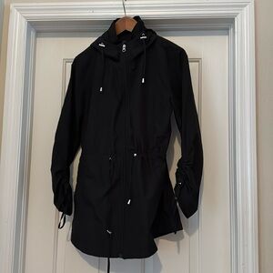 Jones, New York women’s lightweight black zip up rain jacket.
